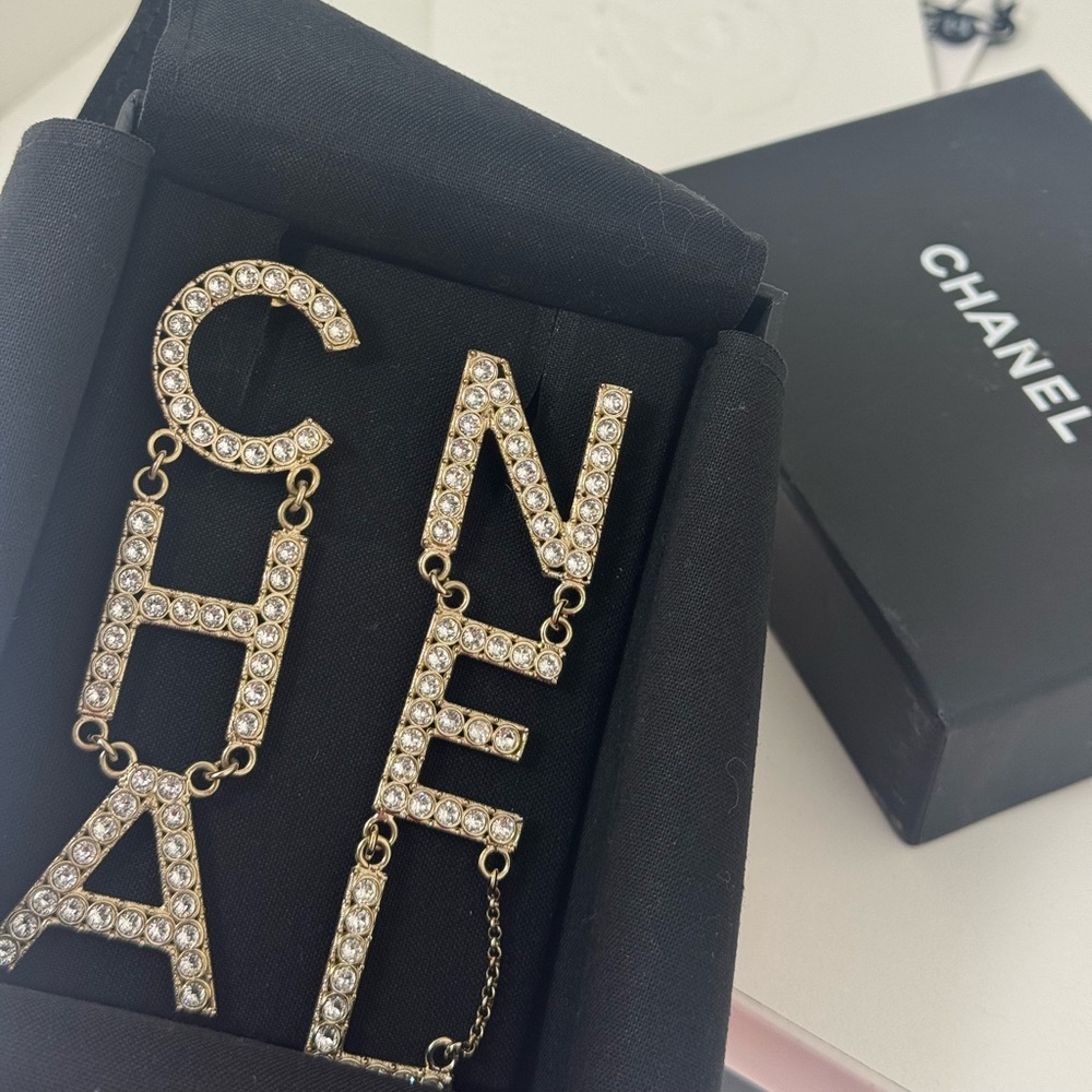 CHANEL Gold Crystal CHA-NEL Logo Drop Earrings